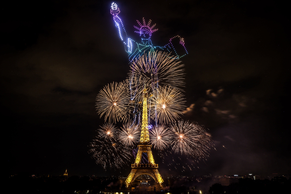 Fireworks and drones illuminate the Eiffel Tower in Paris, during the eve of Bastille Day celebrations late Monday, July 13, 2026. (AP Photo
