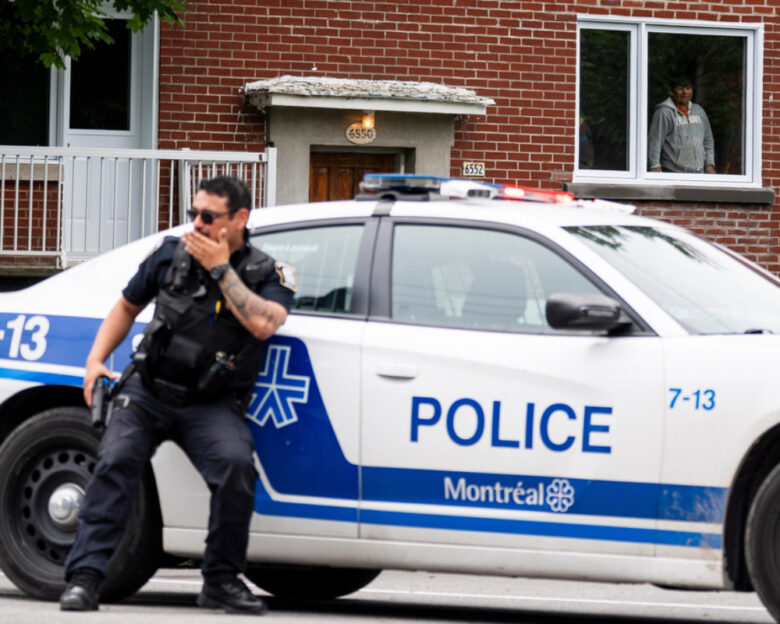 A residents looks on as Montreal police work the scene of a shooting in Montreal, Monday, June 22, 2026.