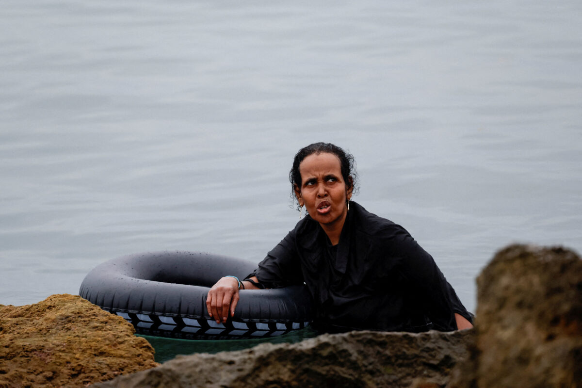 A migrant holds an inflatable ring while in the water, amid mass crossings of migrants on foot and by sea from Morocco into Spanish territory in Ceuta, Spain, July 31, 2026. REUTERS