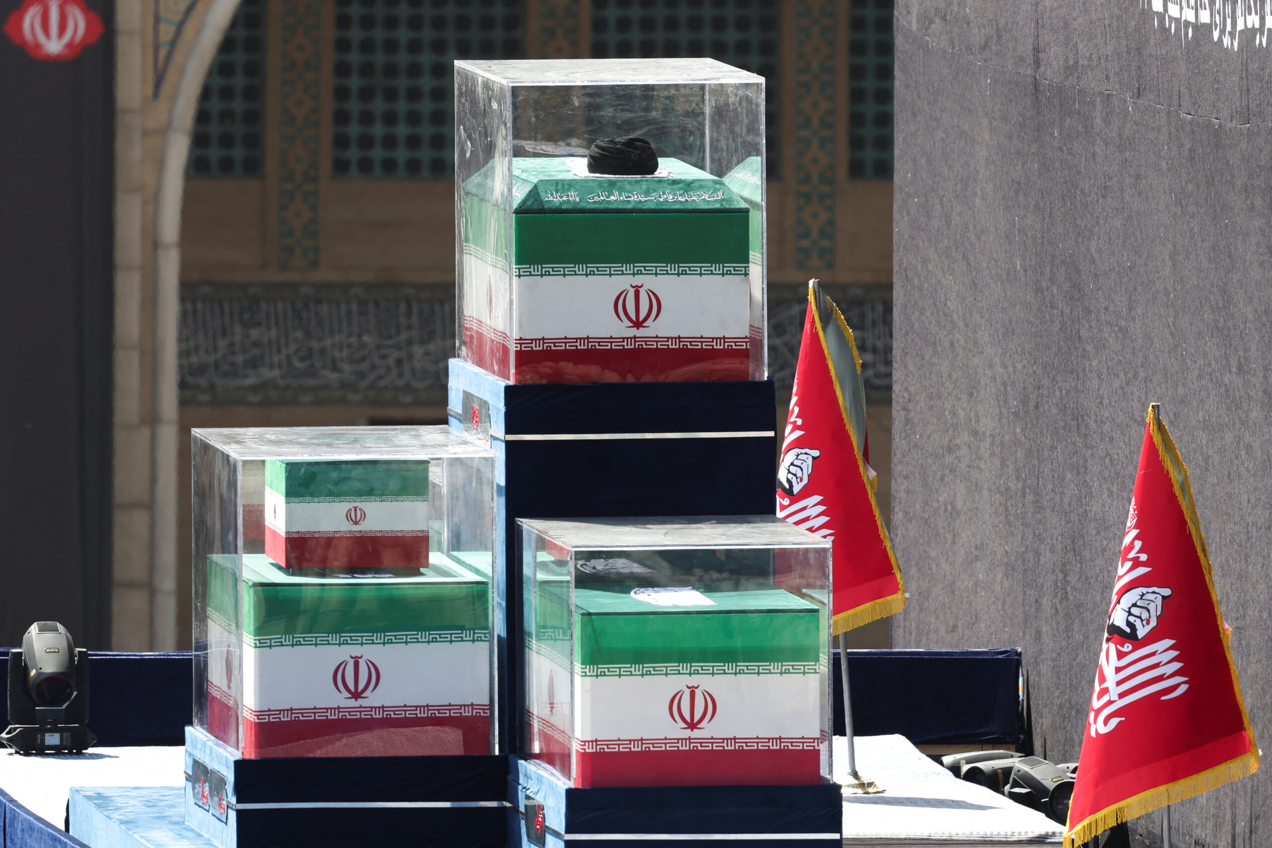 A turban is placed over the coffin of Iran's late Supreme Leader Ayatollah Ali Khamenei, near the coffins of Khamenei's family members in the colours of Iranian flags on the stage, as people gather for a public farewell ceremony to pay their respects to late Supreme Leader Ayatollah Ali Khamenei, who was killed on February 28 in Israeli and U.S. airstrikes, at the Imam Khomeini Grand Mosalla, in Tehran, Iran July 5, 2026. REUTERS