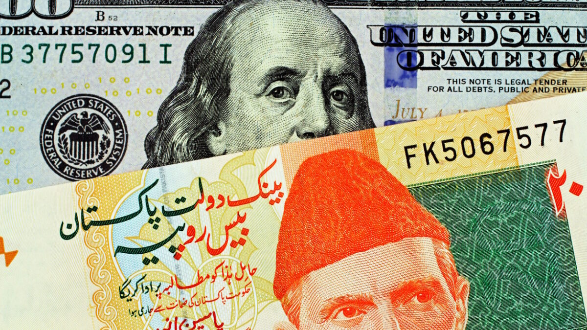 A macro image of a twenty rupee bank note from Pakistan close up with an American one hundred dollar bill