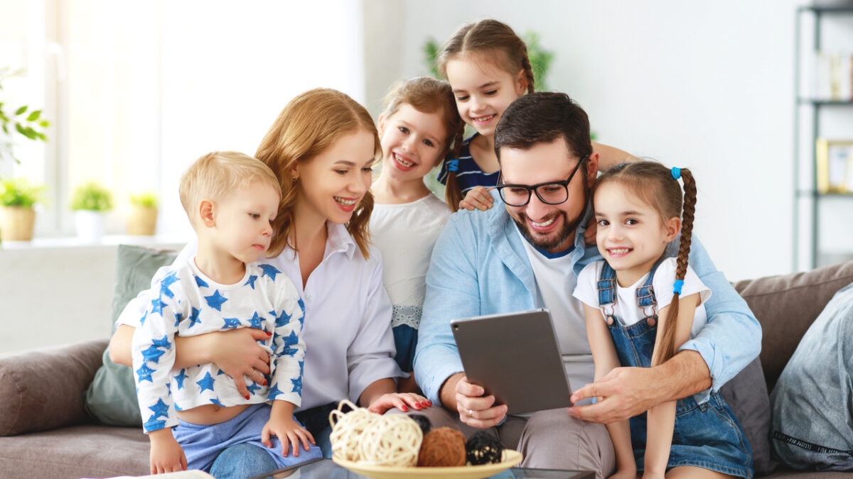large family mother, father and four children with tablet computer at home