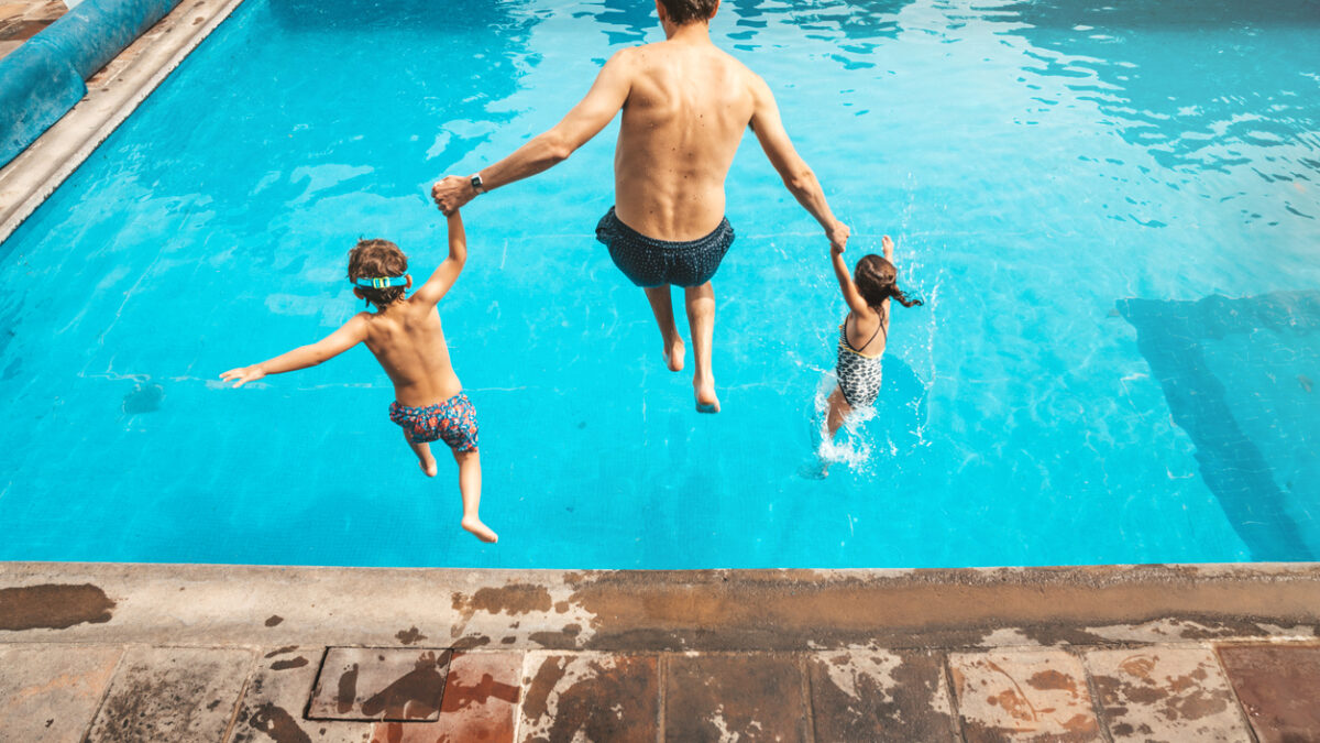 Father and son having fun on the pool