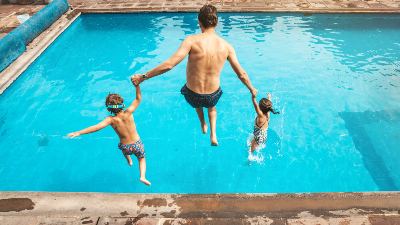Father and son having fun on the pool