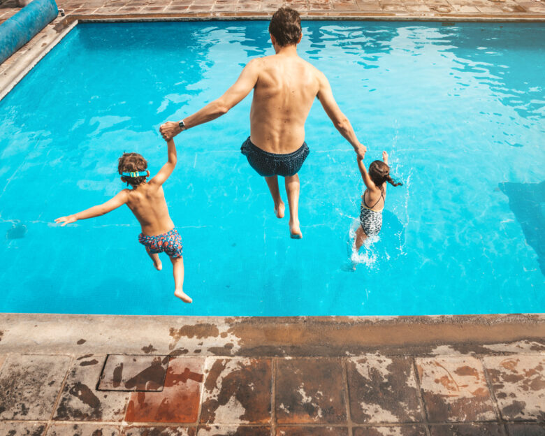 Father and son having fun on the pool