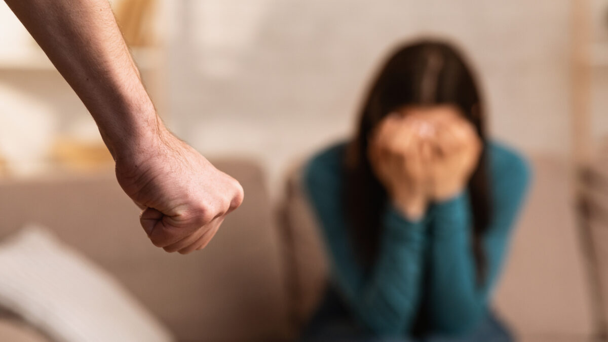 Domestic Violence During Quarantine. Man threatening his girlfriend with fist, scared woman hiding her face in hands