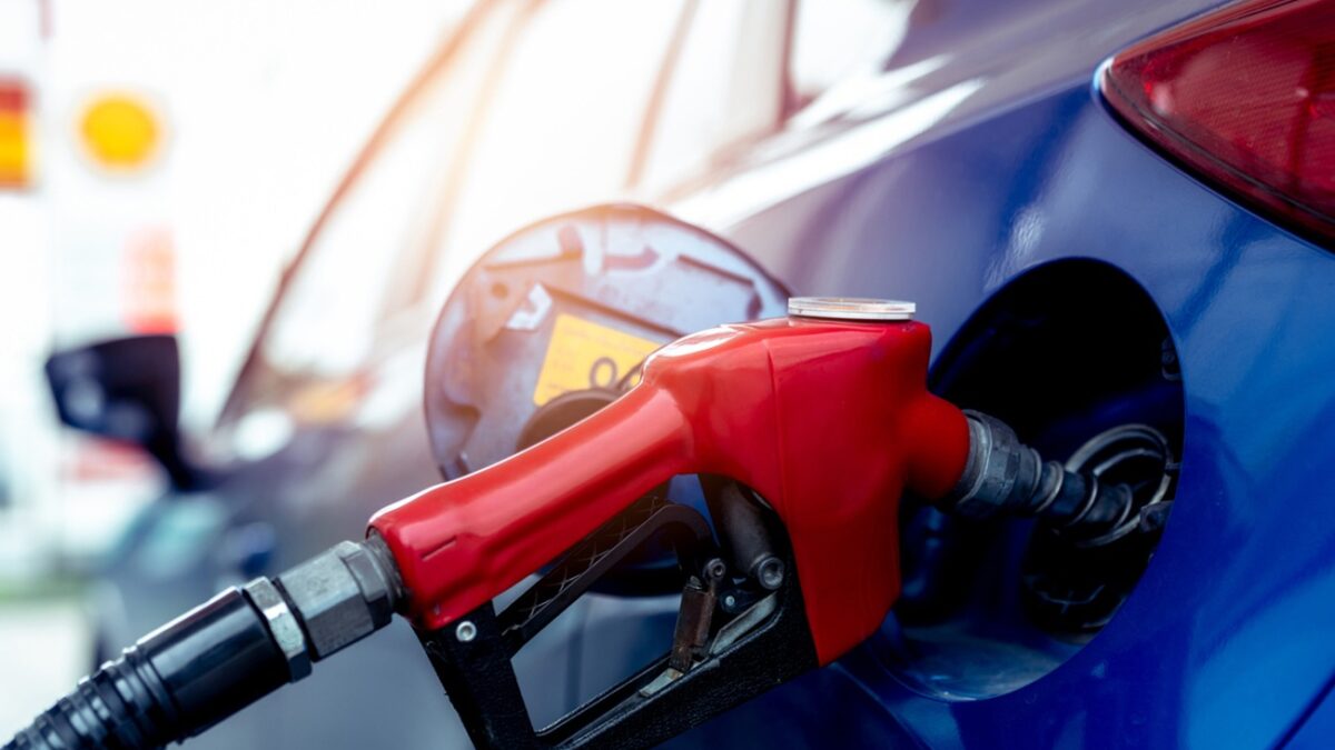 Car fueling at gas station. Refuel fill up with petrol gasoline. Petrol pump filling fuel nozzle in fuel tank of car at gas station. Petrol industry and service. Petrol price and oil crisis concept.