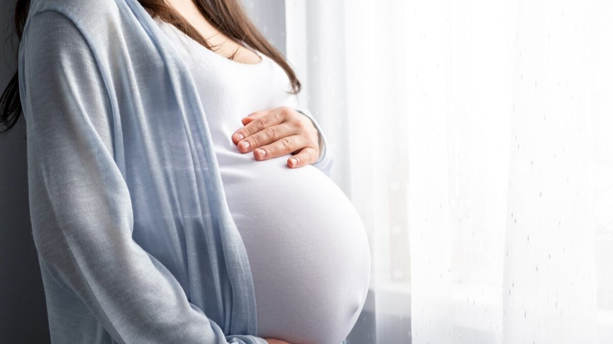 healthy pregnancy. Side view pregnant woman with big belly advanced pregnancy in hands. Banner copyspace for text. Elegant mother waiting baby