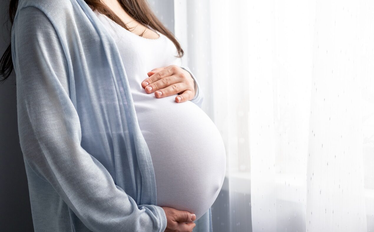 healthy pregnancy. Side view pregnant woman with big belly advanced pregnancy in hands. Banner copyspace for text. Elegant mother waiting baby