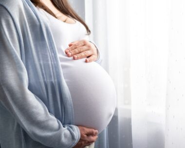 healthy pregnancy. Side view pregnant woman with big belly advanced pregnancy in hands. Banner copyspace for text. Elegant mother waiting baby