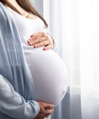 healthy pregnancy. Side view pregnant woman with big belly advanced pregnancy in hands. Banner copyspace for text. Elegant mother waiting baby