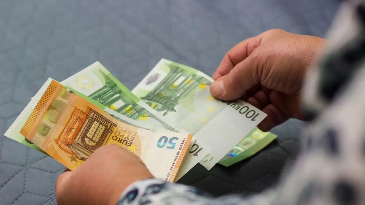 Senior woman hands counting money at home