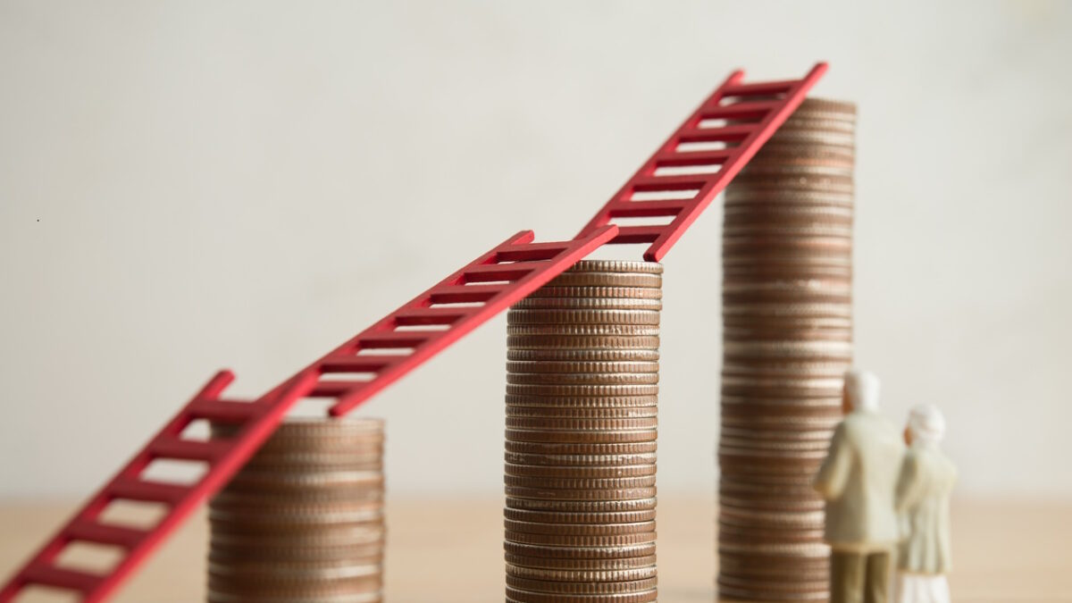 Love old senior couple looking at growth stack coins graph chart with red ladder. Financial planning for retirement, savings, pension, gain return on investment, wealth and so on concept.