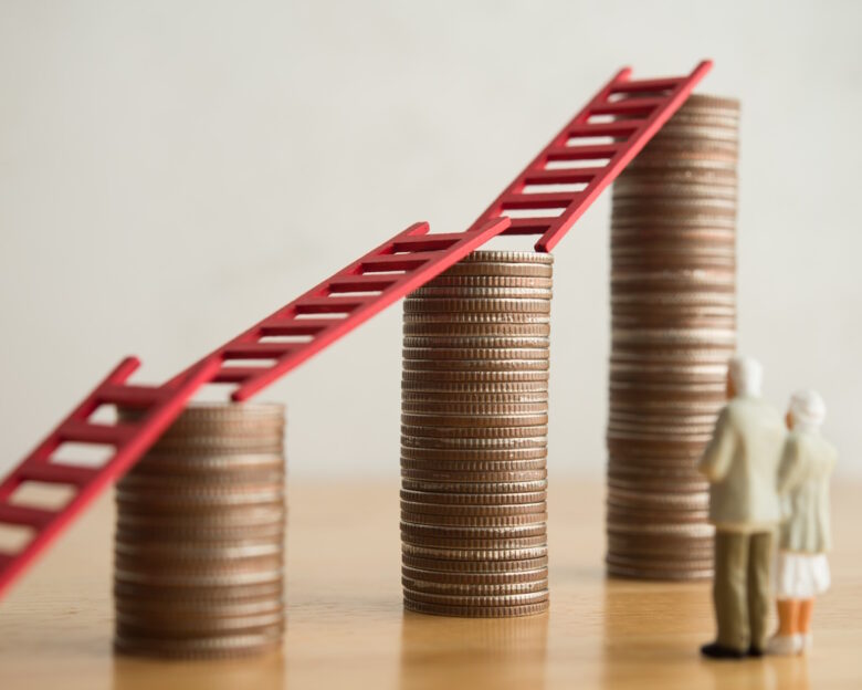 Love old senior couple looking at growth stack coins graph chart with red ladder. Financial planning for retirement, savings, pension, gain return on investment, wealth and so on concept.