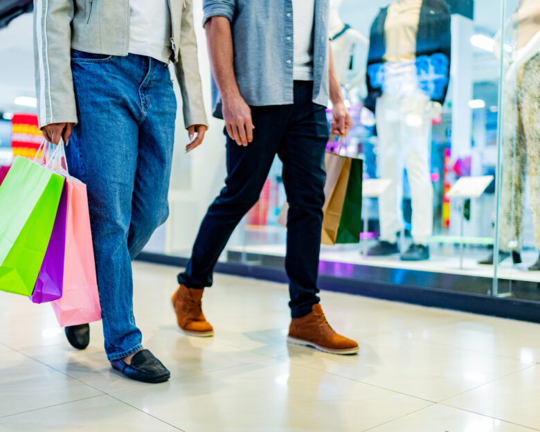 Low section of couple walking with shopping bag atmall