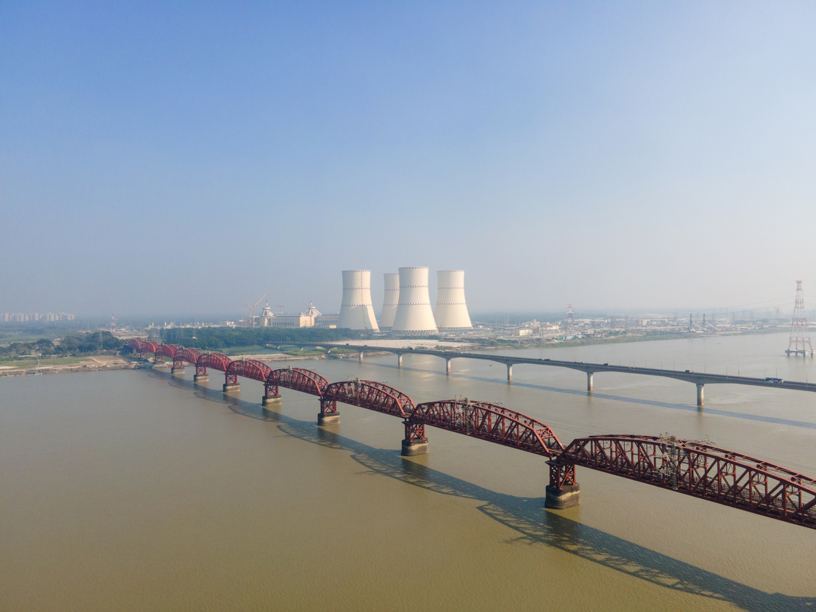 Aerial view of the historic Hardinge Bridge and Lalon Shah Bridge spanning the Padma River with the Rooppur Nuclear Power Plant visible in the background in Ishwardi, Bangladesh. The Rooppur Nuclear Power Plant is the country’s first nuclear power facility and a major national infrastructure project.