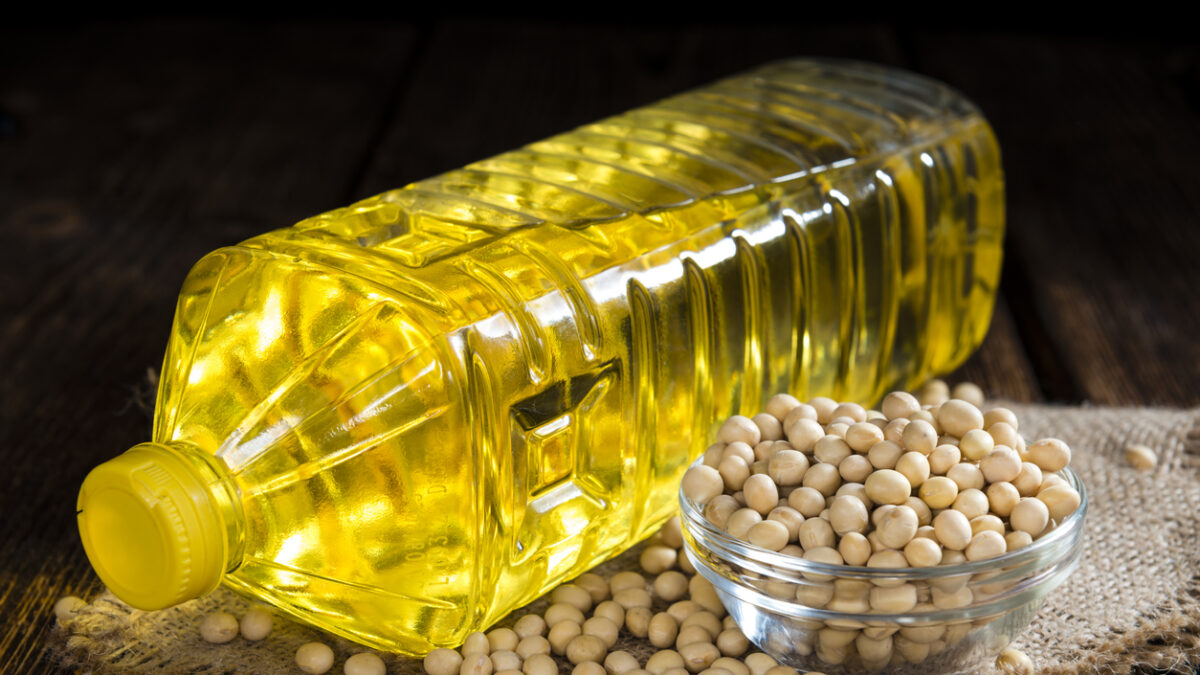 Bottle of Soy Oil on dark rustic wooden background