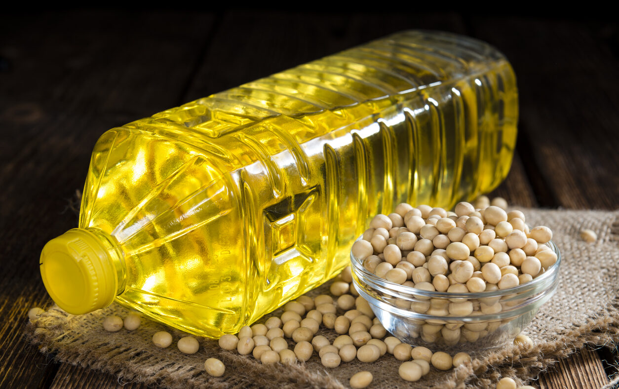Bottle of Soy Oil on dark rustic wooden background