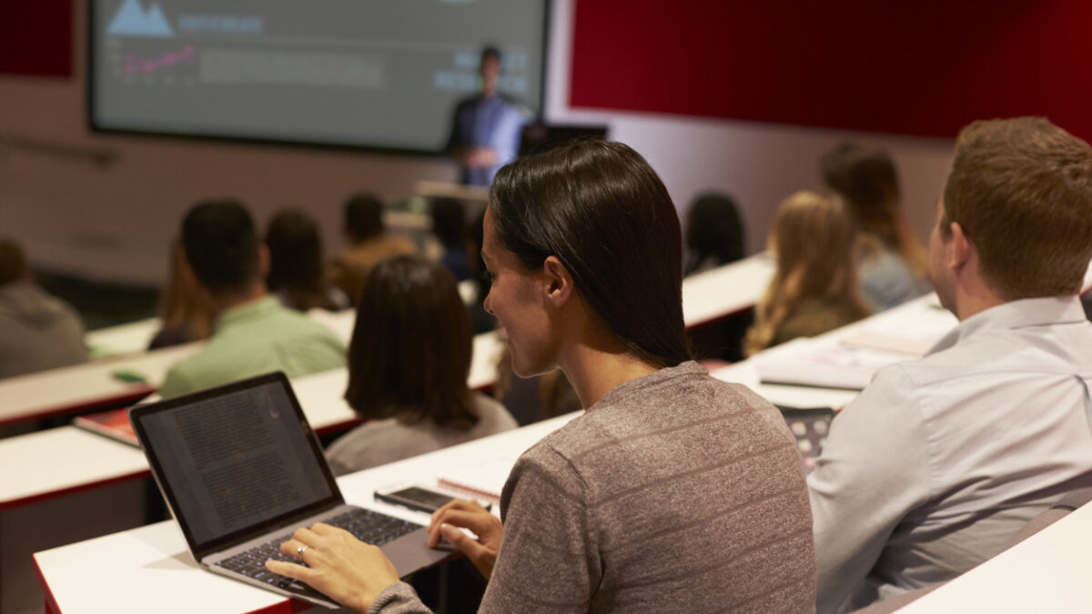 Adult student using laptop computer at a university lecture