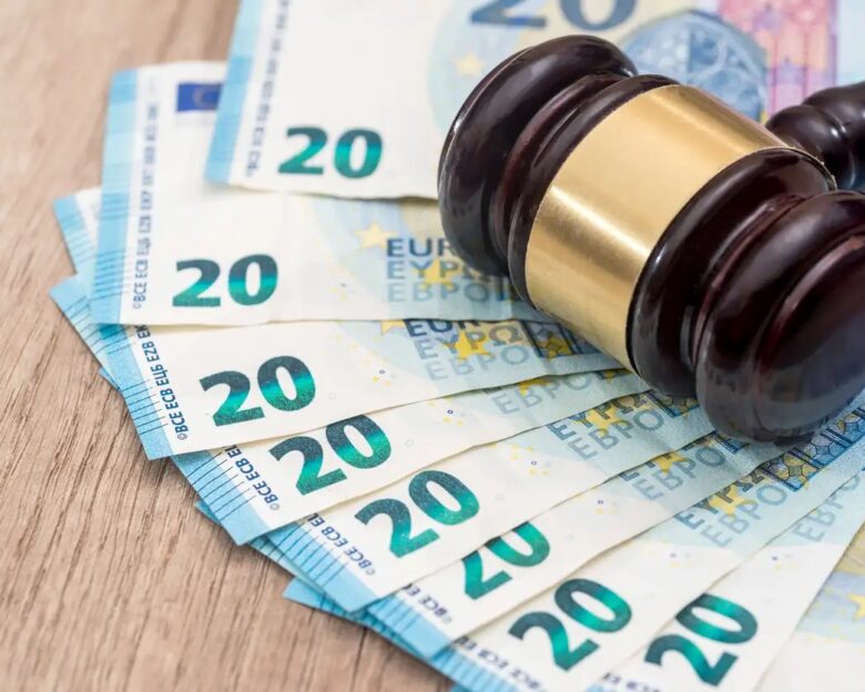 Wooden gavel with 20 euro banknotes on desk