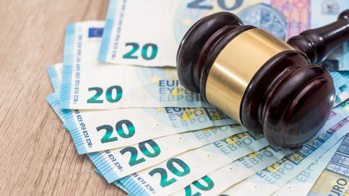 Wooden gavel with 20 euro banknotes on desk
