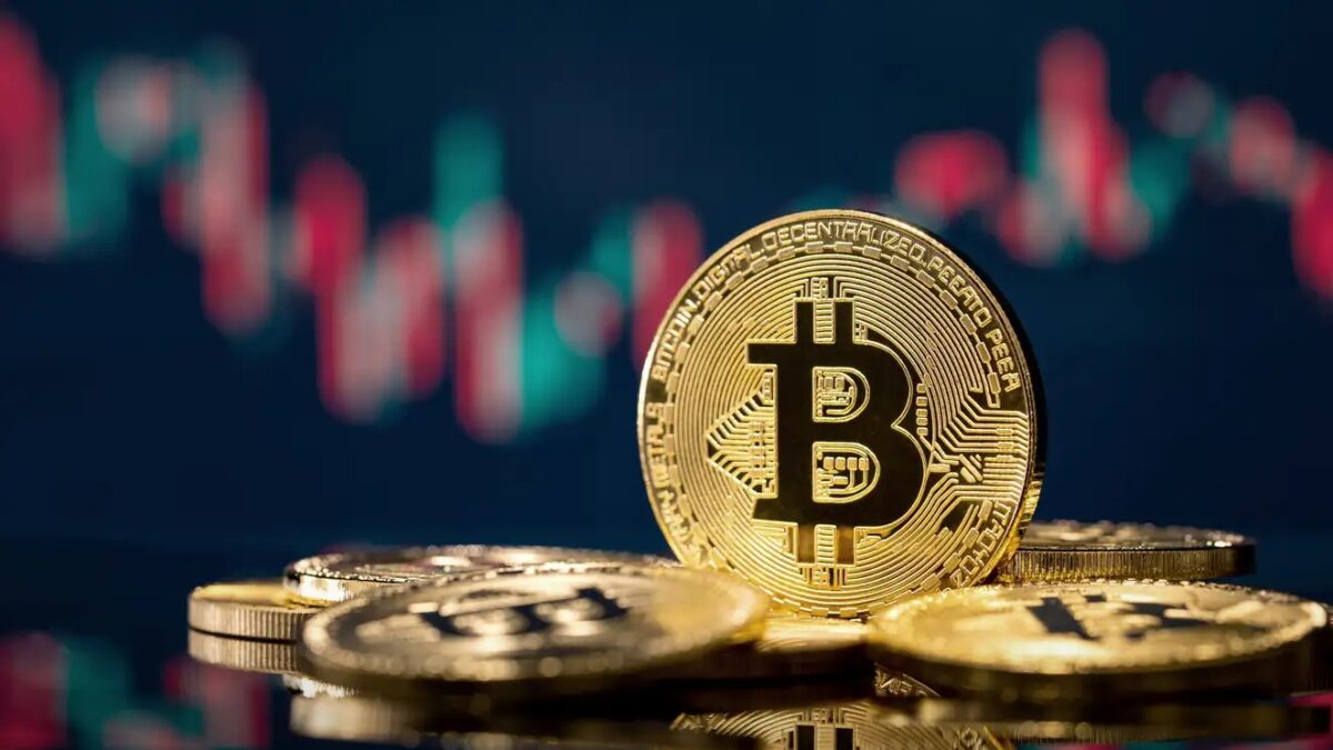 Golden bitcoin coin over defocused stock chart with copy space, Olsztyn, Poland 13 July 2021