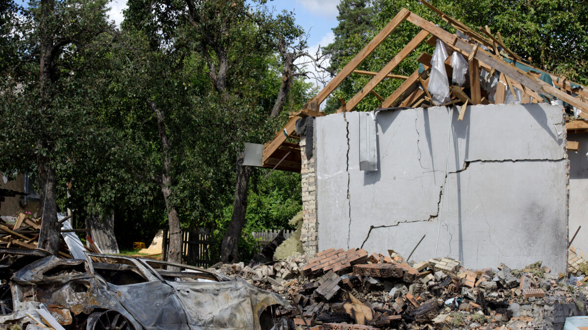 A crushed car is outside a house damaged by a missile strike, Kapitanivka village, Kyiv region, Ukraine, on July 29, 2026. On July 24, 2026, Russian forces launched ballistic missiles at a private training ground in Bucha district where a weapons exhibition was taking place. The missiles also struck a nearby residential area, damaging private houses and cars. Twelve people were killed, and around 100 were injured in the attack. (Photo by Marianna Kotyk/Ukrinform/NurPhoto)NO USE FRANCE