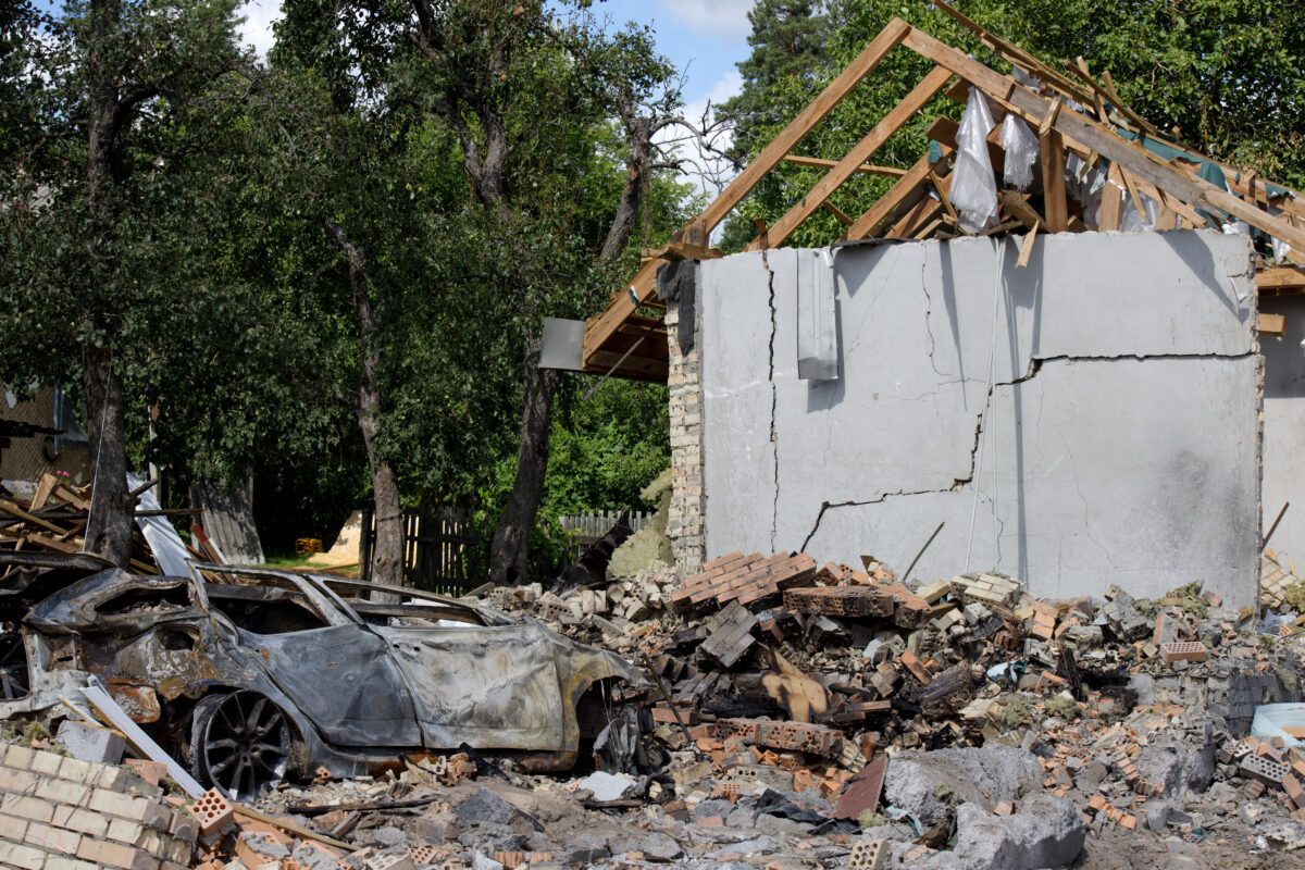 A crushed car is outside a house damaged by a missile strike, Kapitanivka village, Kyiv region, Ukraine, on July 29, 2026. On July 24, 2026, Russian forces launched ballistic missiles at a private training ground in Bucha district where a weapons exhibition was taking place. The missiles also struck a nearby residential area, damaging private houses and cars. Twelve people were killed, and around 100 were injured in the attack. (Photo by Marianna Kotyk/Ukrinform/NurPhoto)NO USE FRANCE