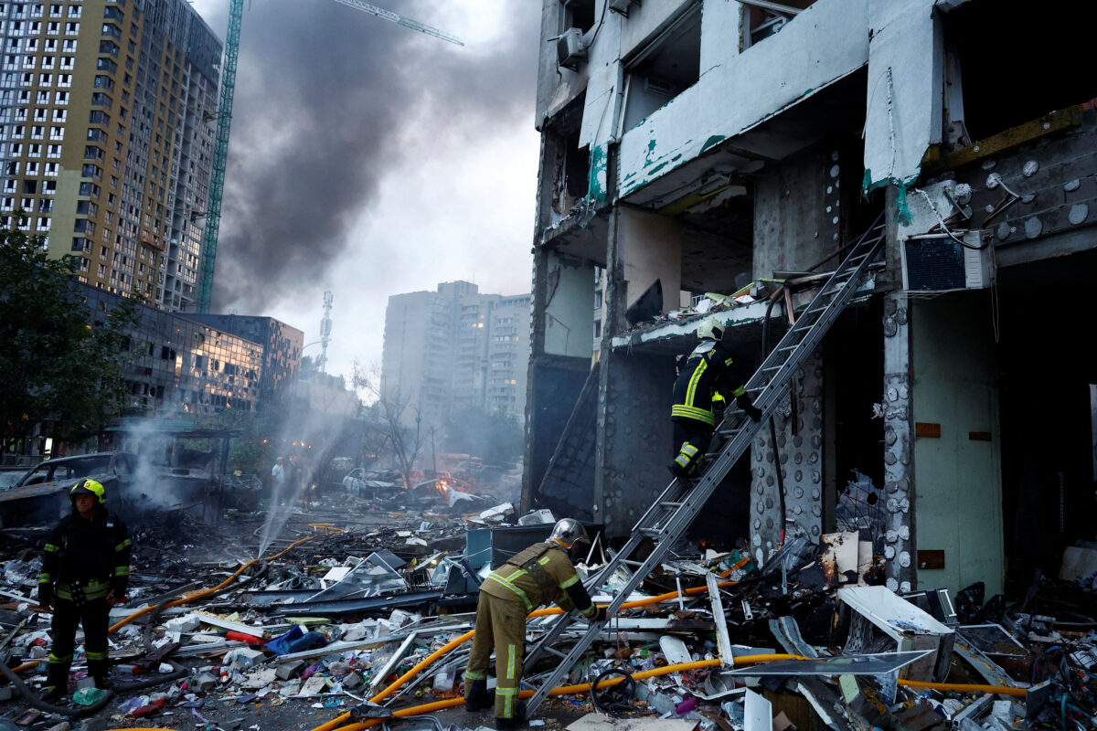 A rescuer climbs up a ladder at the site of an apartment building, which was heavily damaged during Russian missile and drone strikes, amid Russia's attack on Ukraine, in Kyiv, Ukraine, July 6, 2026. REUTERS