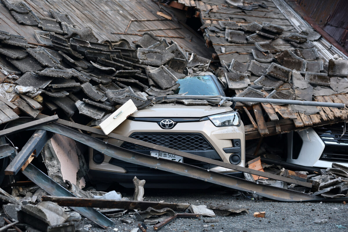 A car sits crushed beneath debris from a collapsed building after an earthquake with a magnitude of 7.1 struck Japan's southern Kumamoto prefecture, in Yatsushiro City, Japan, July 29, 2026. REUTERS/Issei Kato