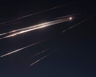 Missiles illuminate the night sky during an Iranian missile attack in Jerusalem, early Sunday, June 15, 2025.