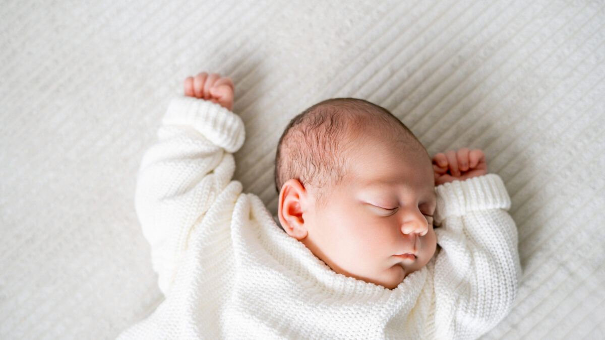 Little newborn boy in knitted clothes sleeping. baby.
