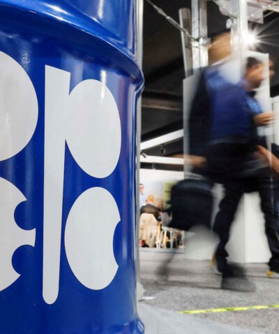 FILE PHOTO: People walk past an installation depicting barrel of oil with the logo of Organization of the Petroleum Exporting Countries (OPEC) in Baku, Azerbaijan November 19, 2024.
