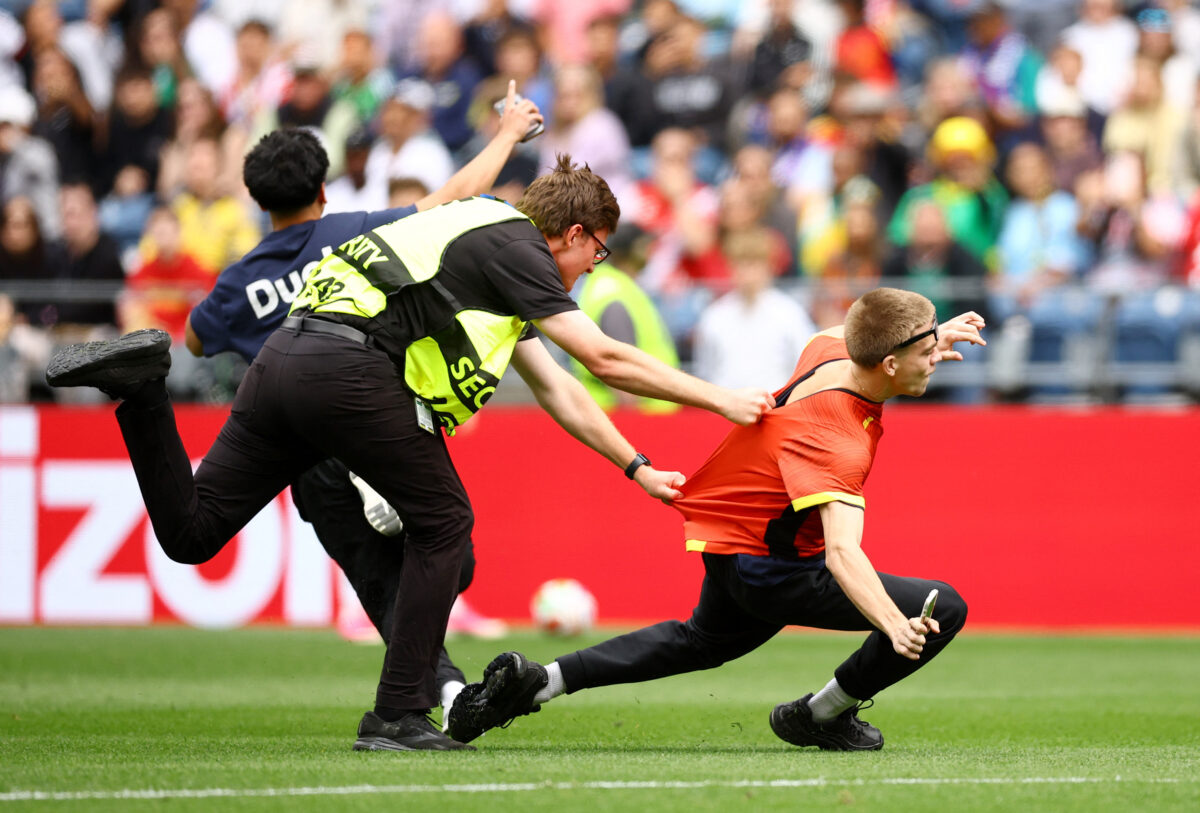 Soccer Football - FIFA World Cup 2026 - Round of 32 - Belgium v Senegal - Seattle Stadium, Seattle, Washington, U.S. - July 1, 2026 Security staff attempt to apprehend a pitch invader REUTERS