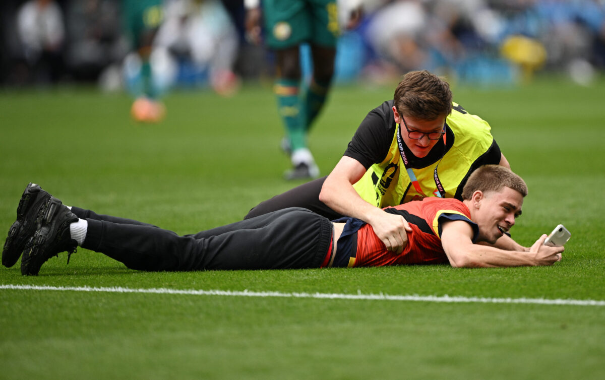 Soccer Football - FIFA World Cup 2026 - Round of 32 - Belgium v Senegal - Seattle Stadium, Seattle, Washington, U.S. - July 1, 2026 A pitch invader is detained by a steward IMAGN IMAGES via Reuters