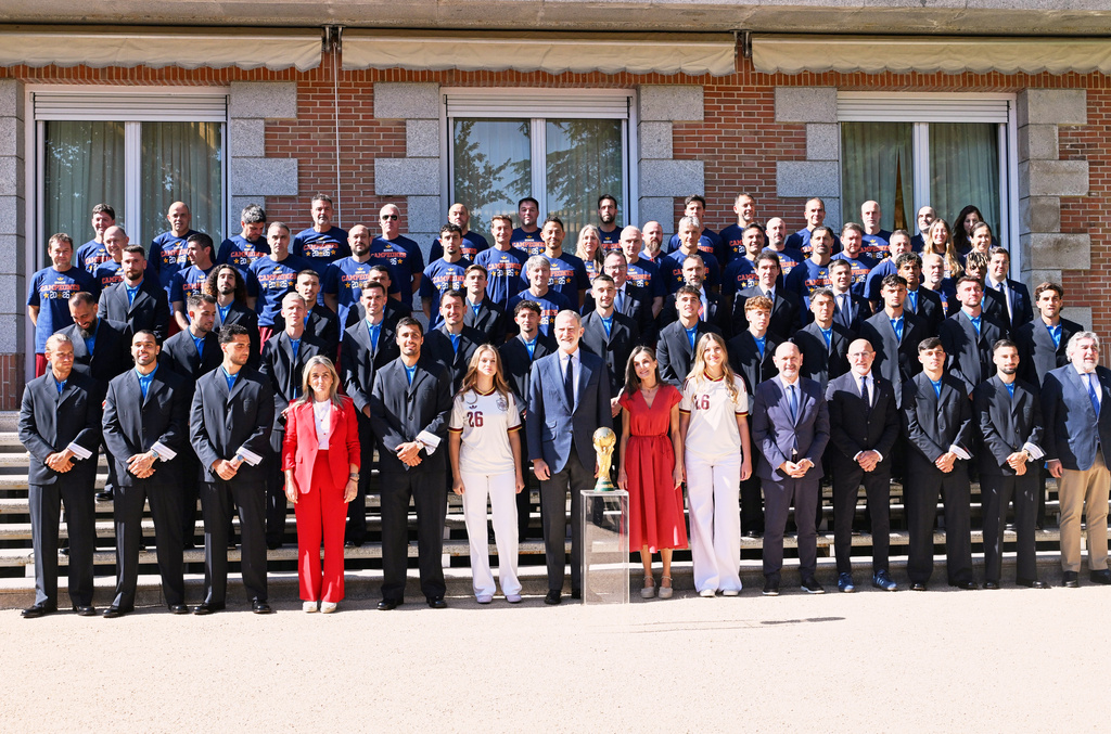 Spain's King Felipe VI and Queen Letizia, accompanied by Princess Leonor and Infanta Sofia, pose with players from Spain's national soccer team at Zarzuela Palace in Madrid on Monday, July 20, 2026, after the team was crowned World Cup champion. (Jose Oliva