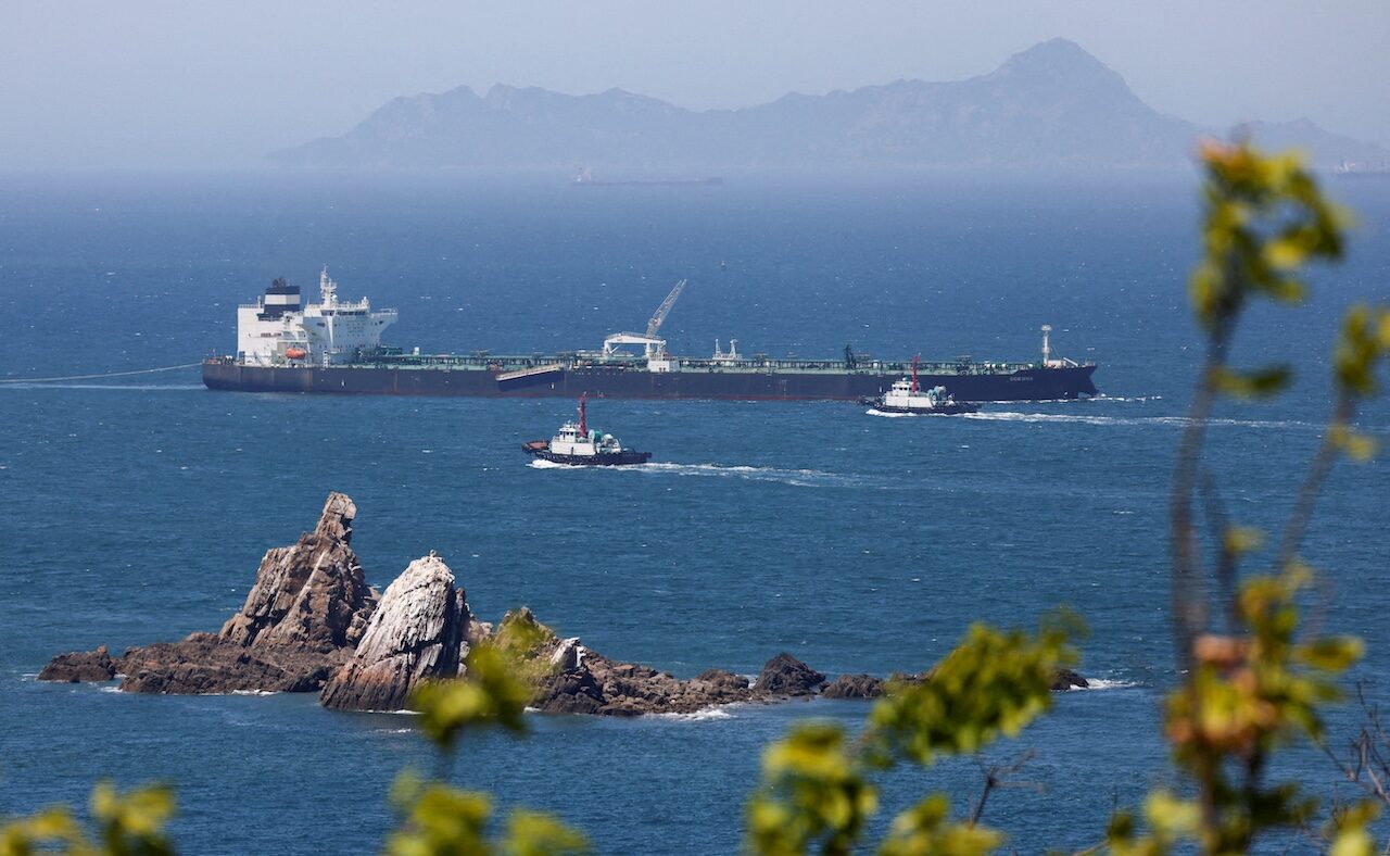FILE PHOTO: Tugboats guide the crude oil tanker Odessa, carrying UAE crude after passing through the Strait of Hormuz with its Automatic Identification System transponder turned off, navigates the waters at Daesan port, where it is expected to discharge crude oil, in Seosan, South Korea, May 8, 2026. REUTERS/Kim Soo-hyeon/File Photo