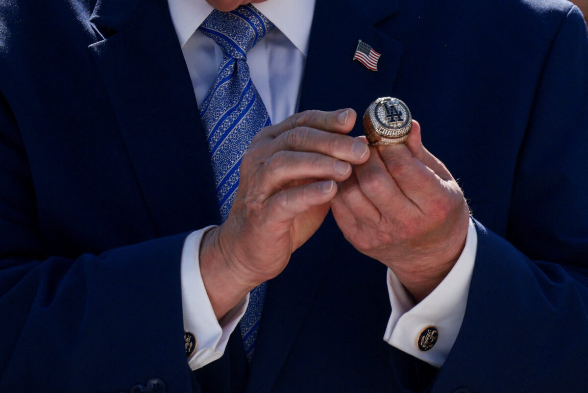 U.S. President Donald Trump holds a World Series ring, while hosting a reception for the reigning Major League Baseball (MLB) World Series champion Los Angeles Dodgers in the Rose Garden at the White House, Washington, D.C., U.S., July 23, 2026. REUTERS
