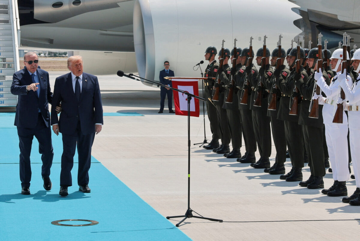 U.S. President Donald Trump walks with Turkish President Tayyip Erdogan as he arrives aboard Air Force One at Etimesgut Air Base, for a NATO summit, in Ankara, Turkey, July 7, 2026. REUTERS