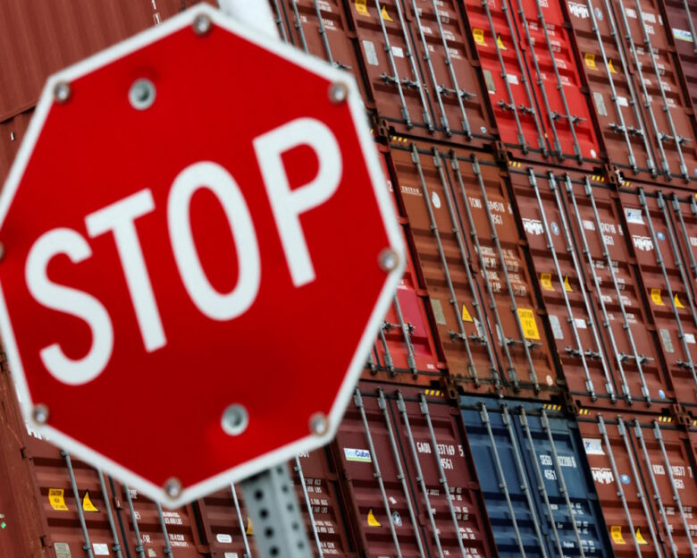 FILE PHOTO: A stop sign is pictured in front of shipping containers at the Port of Long Beach in Long Beach, California, U.S., July 11, 2025.