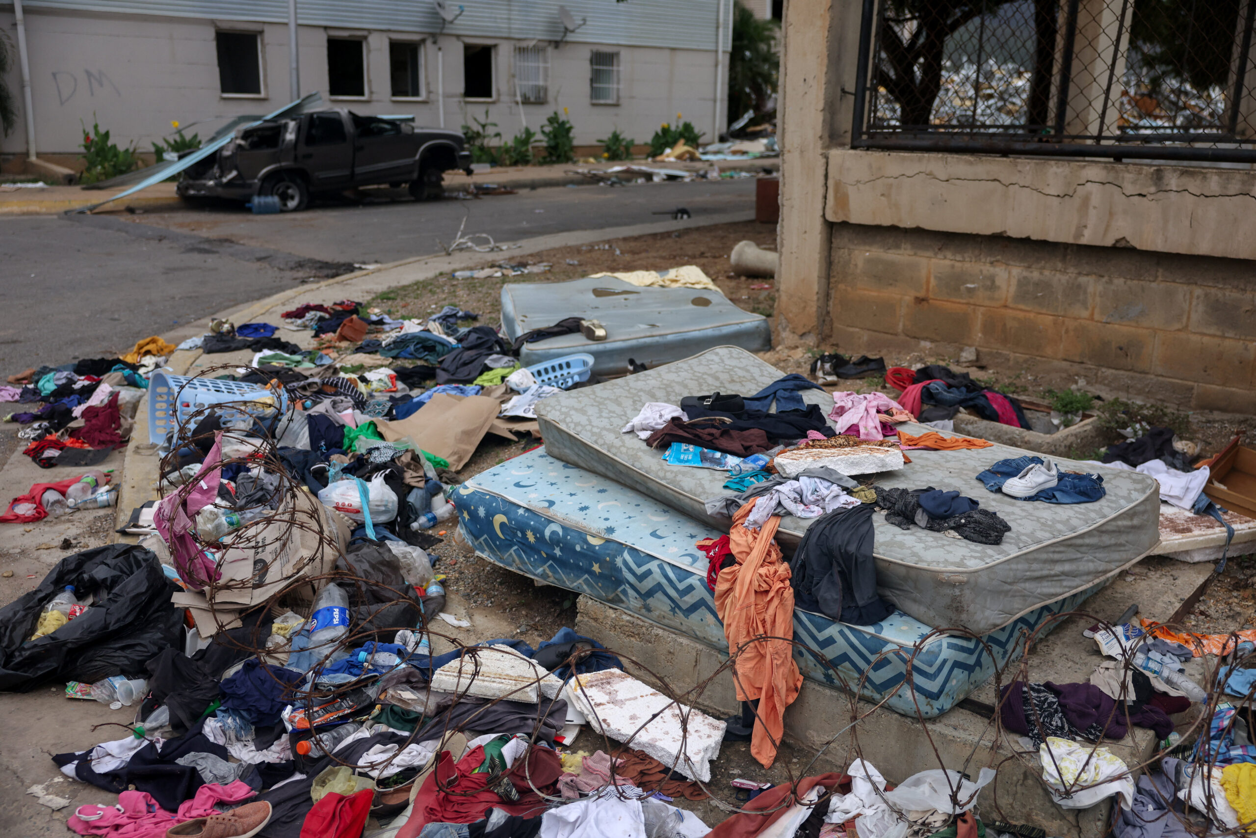 Belongings and a damaged vehicle on the street in the aftermath of the June 24 earthquakes, at the Hugo Chavez housing complex, built under the Venezuelan government's 'Gran Mision Vivienda' initiative, in Catia la Mar, La Guaira state, Venezuela, July 13, 2026. REUTERS