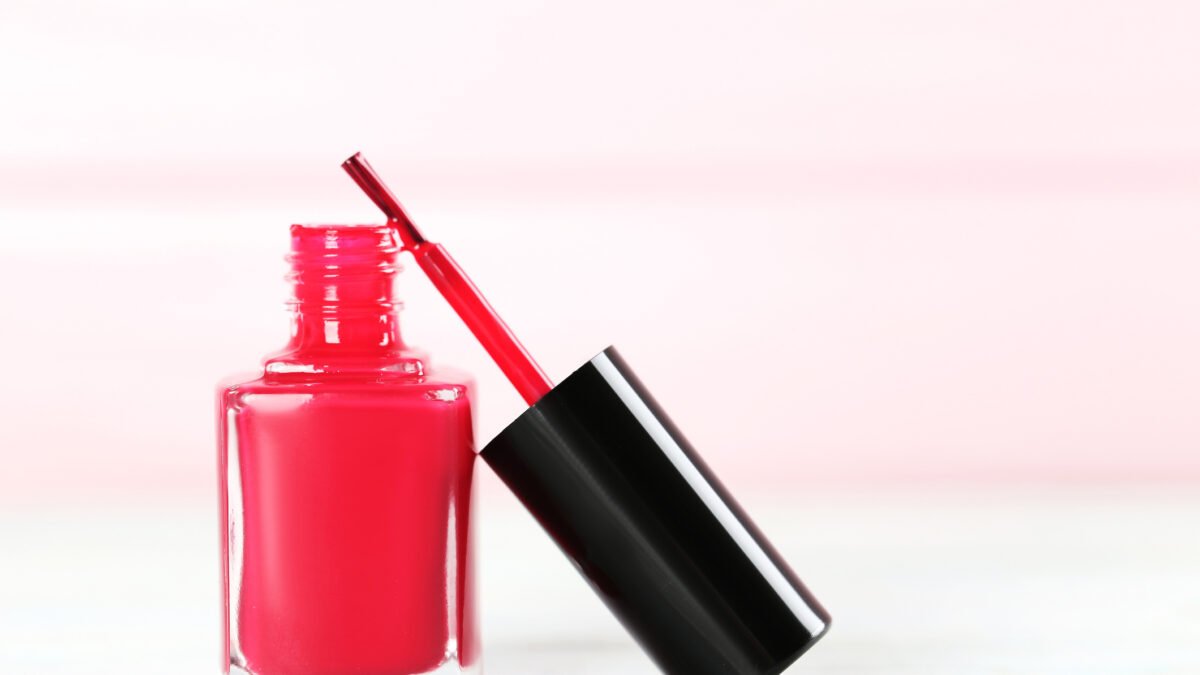 Bottle of nail polish on a wooden table