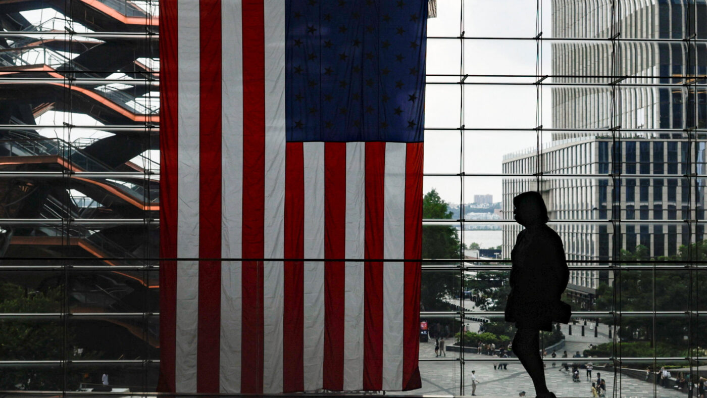 A shopper walks past a U.S. flag at Hudson Yards in New York City, U.S., July 27, 2026.