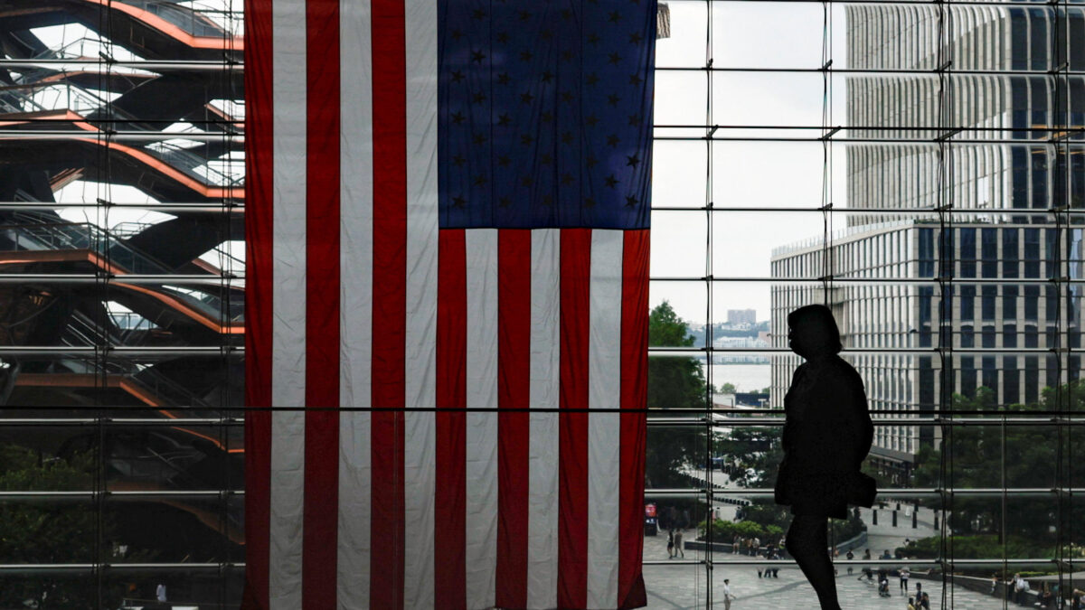 A shopper walks past a U.S. flag at Hudson Yards in New York City, U.S., July 27, 2026.