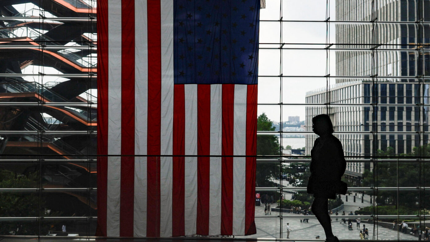 A shopper walks past a U.S. flag at Hudson Yards in New York City, U.S., July 27, 2026.