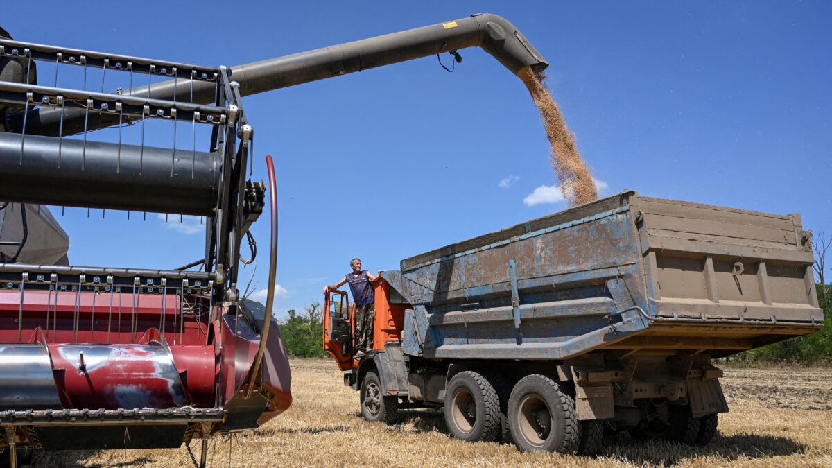 FILE PHOTO: A combine loads a truck with wheat during harvesting in a field in the Rostov region, Russia, July 14, 2026.