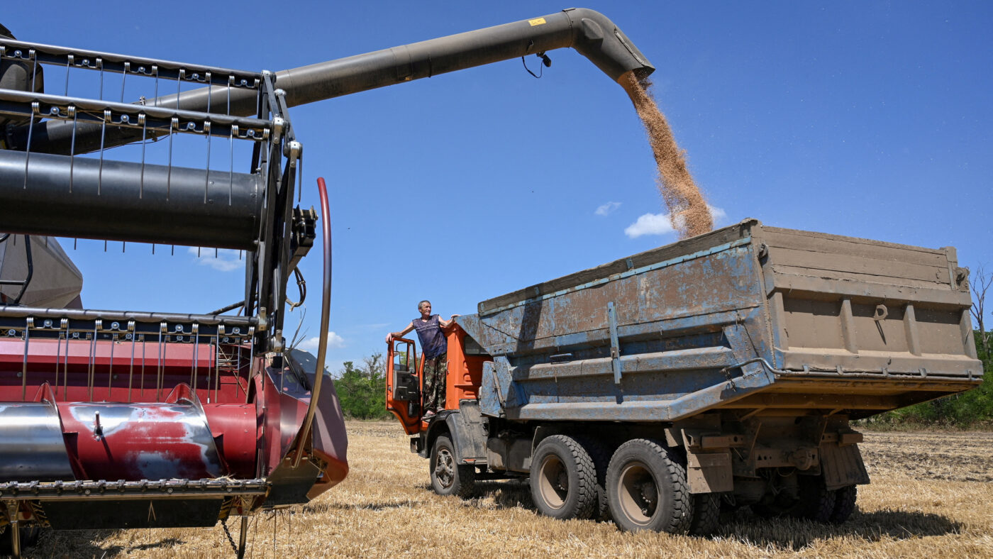 FILE PHOTO: A combine loads a truck with wheat during harvesting in a field in the Rostov region, Russia, July 14, 2026.