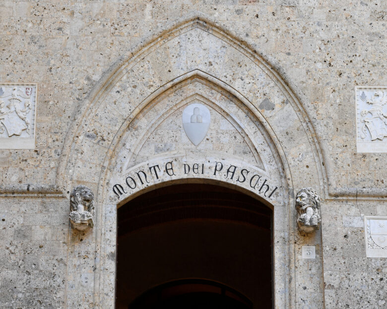 FILE PHOTO: FILE PHOTO: View of the entrance to the headquarters of Monte dei Paschi di Siena (MPS), the oldest bank in the world, which is facing massive layoffs as part of a planned corporate merger, in Siena, Italy, August 11, 2021.