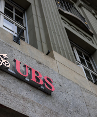 FILE PHOTO: The UBS logo is pictured on a building next to the Federal Palace of Switzerland, in Bern, Switzerland, December 11, 2025.
