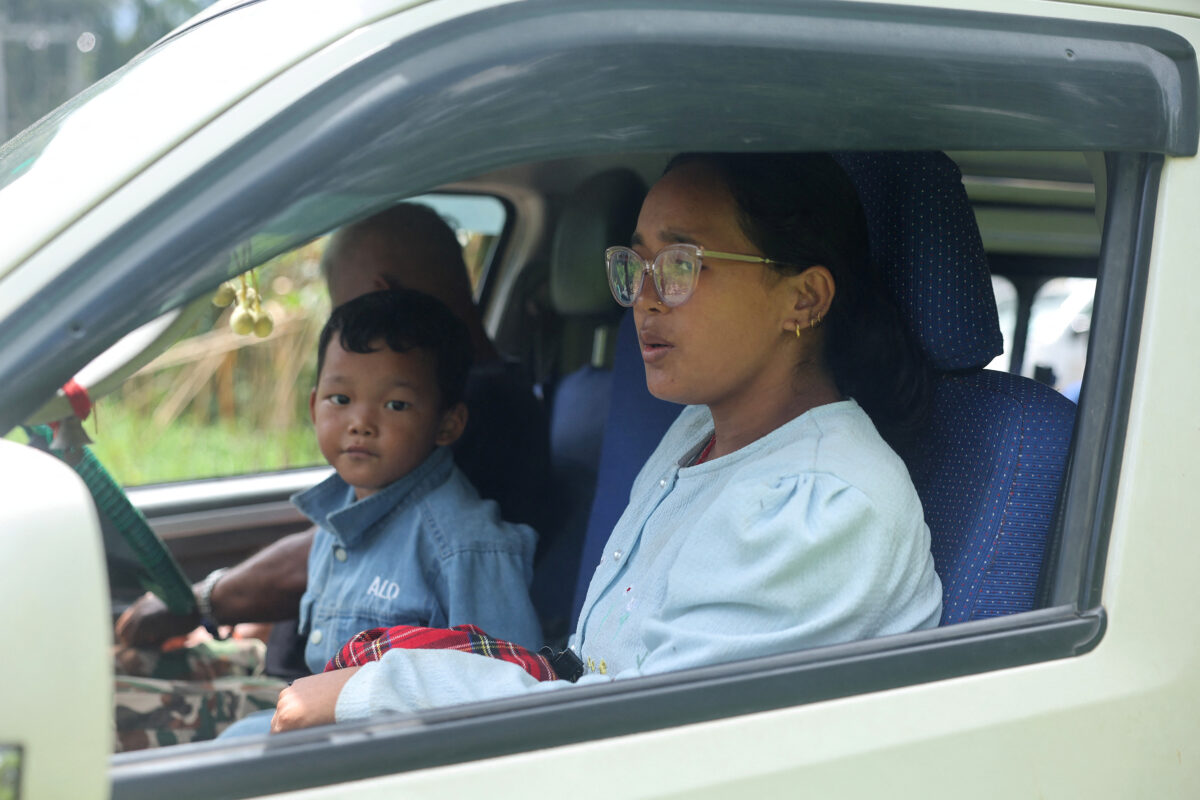 Matti Maya Tamang, 28, along with her son Jenish Ghale, 5, sit in a van as they leave for Kathmandu to meet her son Zoyal Ghale, 8, after they were separated by the deadly flash floods and mudslide, in Rasuwa district, in Nepal, August 28, 2026. REUTERS
